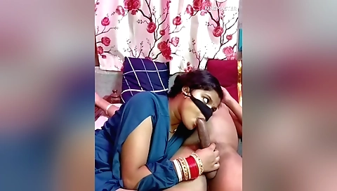 Indian brunette sucks her husband's dick in the bed