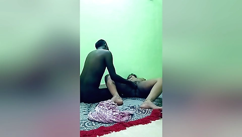 Amateur couple watching and making love in kitchen