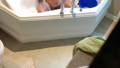 Amateur hot brunette showering while hidden cam is filming