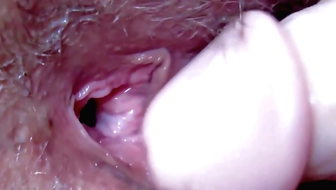 Hairy mature lady with a hairy pussy fucks in front of the camera