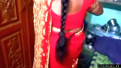 Brunette with a red shari changes outfit and gets ready