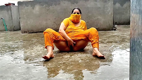 Indian brunette rides her own cock in front of the rain