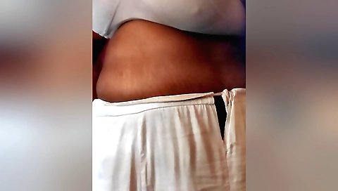 Indian girl wearing a red sari shows off her boobs