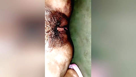 Girl with a hairy pussy takes off her top in solo video